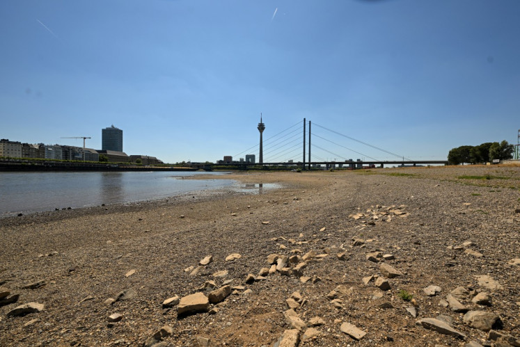 The partially dried-up river bed of the Rhine is pictured in Duesseldorf, western Germany, on July 28, 2026, following exceptionally hot weather. 