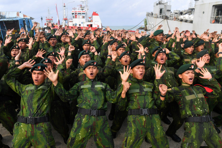 Soldiers of the Indonesian Military's (TNI) 613th Infantry Battalion/Raja Alam chant during a homecoming ceremony at Semayang Port in Balikpapan, East Kalimantan, on July 22, 2026, after returning from a 12-month border security deployment along the Indonesia&ndash;Papua New Guinea frontier. A total of 450 personnel took part in the mission.