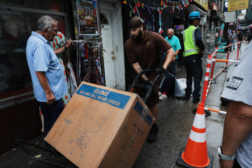 People walk through a shopping district on July 30, 2026 in the Quensborough of New York City. The Commerce Department reported on Thursday that the US economy expanded only at a 1.5 percent pace from April through June, as inflation from the war with Iran continues to weigh on the economy.&nbsp;