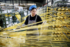 A worker monitors products for export at a packaging factory in Lianyungang, in China's eastern Jiangsu Province, on May 18, 2026.