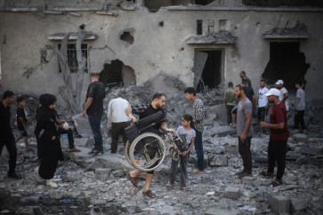 Palestinians inspect damaged and destroyed buildings after they were targeted by Israeli strikes the previous night following warnings to evacuate in Deir al-Balah, central Gaza Strip on July 29, 2026. Gaza remains gripped by daily violence, with both the Israeli military and Hamas accusing one another of violating the truce in effect since October 10. 