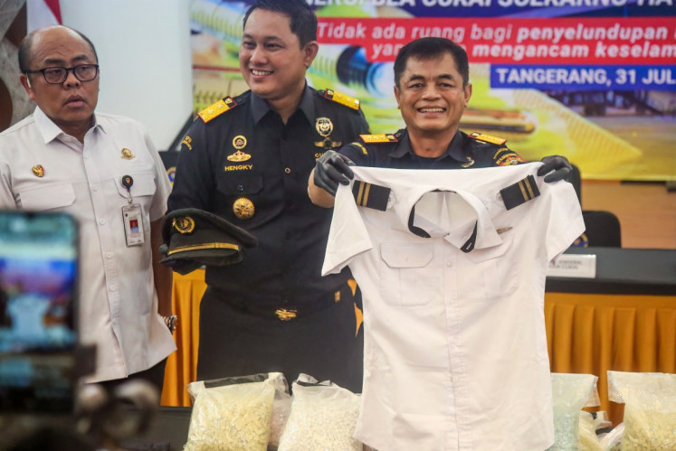 Customs officials display the uniform of a Malaysian pilot and drugs he smuggled as evidence during a press conference at Soekarno-Hatta International Airport in Tangerang, near Jakarta, on July 31, 2026.