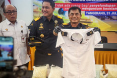 Customs officials display the uniform of a Malaysian pilot and drugs he smuggled as evidence during a press conference at Soekarno-Hatta International Airport in Tangerang, near Jakarta, on July 31, 2026.
