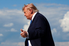 US President Donald Trump flashes a thumbs up while stepping off Air Force One upon arrival at Morristown Municipal Airport in Morristown, New Jersey, on July 31, 2026. President Trump arrived in New Jersey to spend the weekend at his National Golf Club in Bedminster, following a cabinet meeting in Camp David, Maryland.