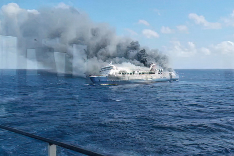 This screen grab from a handout video taken and released on August 2, 2026, by the National Search and Rescue Agency (Basarnas), shows the passenger ship Mutiara Sentosa 2 catching fire in the waters off Madura island, East Java. 