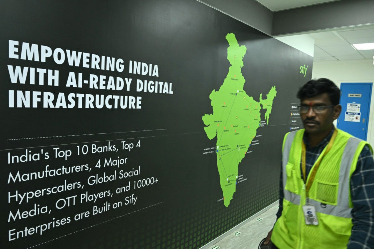 A man walks past signage of Sify Infinit Spaces at its data center at Rabale in Navi Mumbai, India, on July 20, 2026.