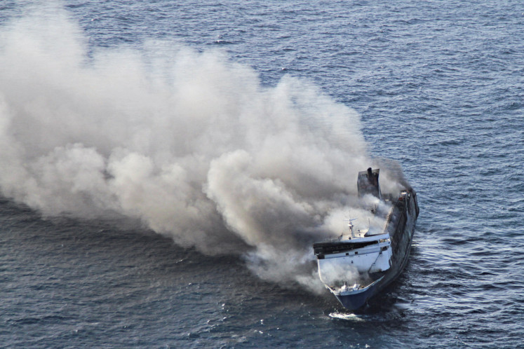 Plumes of smoke rise from the Mutiara Sentosa II, a ferry which caught fire on Aug. 2 off Madura Island in East Java province. 