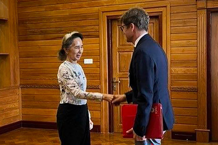 This handout photo taken and released on August 3, 2026 by Myanmar's Presidential Press and Information Bureau (PPIB) shows detained former civilian leader Aung San Suu Kyi (left) meeting with Arnaude de Baecque, resident representative of the International Committee of the Red Cross (ICRC) to Myanmar, in Naypyidaw. 