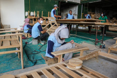 Workers assemble furniture on July 7 at a company in the Wijayakusuma Industrial Estate (KIW) in Semarang, Central Java.