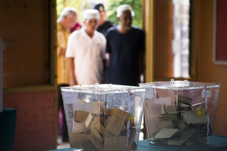 Voters wait to cast their ballots at a polling station during the 14th general election in Alor Setar, Malaysia, on May 9, 2018.