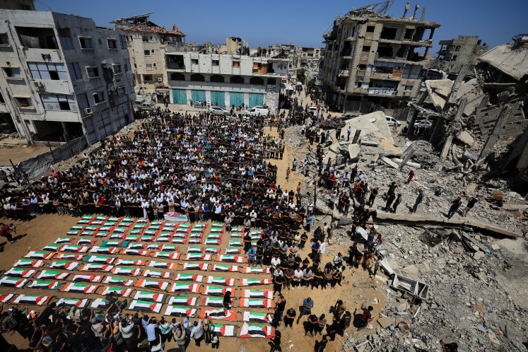 Palestinians attend the funeral of 112 members of the Hassayna and Abu Sharia clan, who were killed in an Israeli strike in 2023 and whose remains were recovered from beneath the rubble, according to Gaza's Civil Defense, in Gaza City, August 4, 2026.