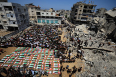 Palestinians attend the funeral of 112 members of the Hassayna and Abu Sharia clan, who were killed in an Israeli strike in 2023 and whose remains were recovered from beneath the rubble, according to Gaza's Civil Defense, in Gaza City, August 4, 2026.