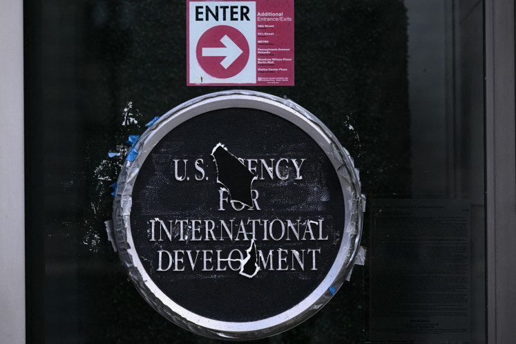 Remnants of signage for the United States Agency for International Development (USAID) are seen on Dec. 29, 2025, on the facade of the Ronald Reagan Building and International Trade Center building in Washington, DC.