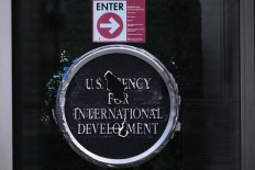 Remnants of signage for the United States Agency for International Development (USAID) are seen on Dec. 29, 2025, on the facade of the Ronald Reagan Building and International Trade Center building in Washington, DC.