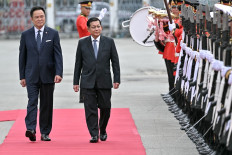 Myanmar's junta chief turned President Min Aung Hlaing (center) and Thailand's Prime Minister Anutin Charnvirakul (left) inspect a guard of honor at a welcoming ceremony during his visit at Government House in Bangkok on August 6, 2026.