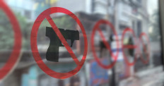 A no weapons sign is seen on the window inside a Transjakarta bus in this undated photo.