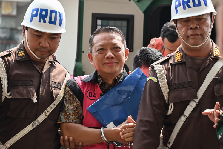 Febrie Adriansyah (center), a former senior prosecutor who is now a suspect in a corruption and money laundering case, arrives at the Attorney General's Office (AGO) headquarters in Jakarta on Aug. 7 for an interrogation by a team of nine senior investigators.