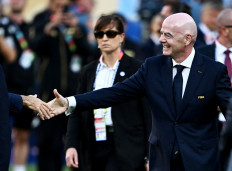 FIFA President Gianni Infantino (right) shakes hands with an unidentified person during the World Cup 2026 trophy presentation after the final match between Spain and Argentina at the New York/New Jersey Stadium in East Rutherford, the United States on July 19, 2026.