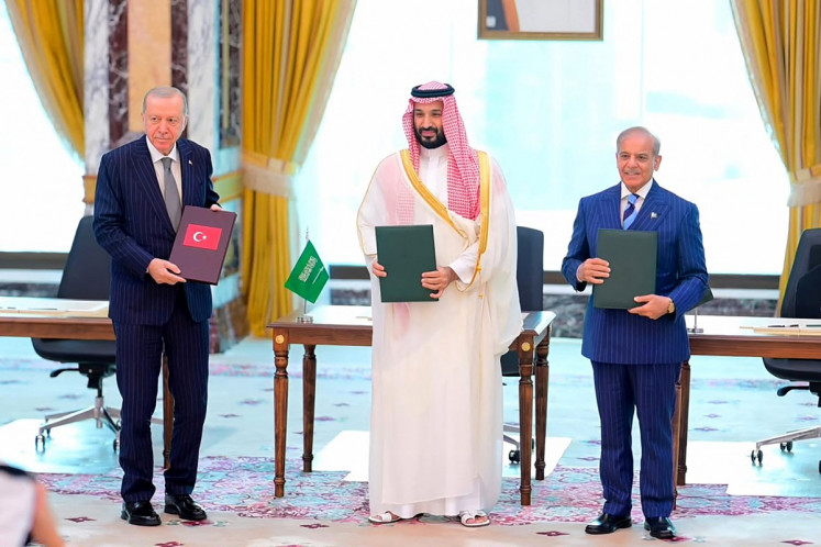 This handout photograph taken and released by Pakistan's Prime Minister's Office on August 7, 2026 shows Saudi Crown Prince Mohammed bin Salman (center), Turkish President Recep Tayyip Erdogan (left) and Pakistani Prime Minister Shehbaz Sharif posing after signing the Mecca Joint Defense Agreement in Mecca, Saudi Arabia. Saudi Arabia, Turkey and Pakistan signed a joint defense agreement on August 7 amid violence in the region from Houthi attacks and the US-Iran war. 