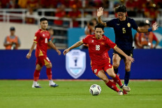 Vietnam's Nguyen Hai Long (#18) vies for the ball with Cambodia's Hikaru Mizuno (#5) during the 2026 ASEAN Championship group stage soccer match between Vietnam and Cambodia at My Dinh National Stadium in Hanoi, Vietnam on August 7, 2026.