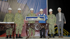 Indonesian Navy chief of staff Adm. Muhammad Ali (third left) and state-owned shipbuilder PT PAL Indonesia president director Kaharudddin Djenod (third right) hold a steel plate in the image of the Scorpene Evolved submarine the steel cutting ceremony on Friday in Surabaya. Indonesia ordered two Scorpene Evolved submarines from French shipbuilder Naval Group which are being constructed domestically in Surabaya. 