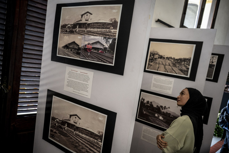 Poet's passage: Visitors view photo archives on Aug. 6, 2026, at the Arthur Rimbaud: A Journey Through Java exhibition at the historic Lawang Sewu building in Semarang, Central Java. The exhibition traces French poet Arthur Rimbaud's journey through Java 150 years ago and the historical ties between Indonesia and France.