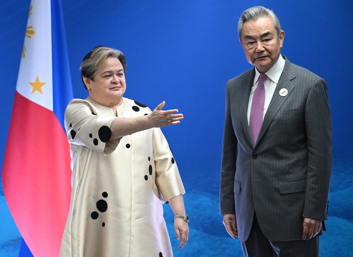 Philippine Foreign Secretary Theresa Lazaro (left) shows the way to China's Foreign Minister Wang Yi during their bilateral meeting on the sidelines of ASEAN Foreign Ministers' Meeting in Pasay, Metro Manila, on July 22, 2026.