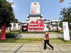 A man walks past the Wisma Danantara Indonesia building on Jl. Jend. Gatot Subroto in South Jakarta on Aug. 11, 2026.