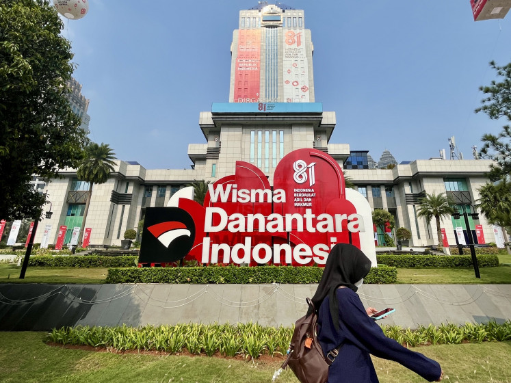 A woman walks past the Wisma Danantara Indonesia building on Aug. 11, 2026, on Jl. Jend. Gatot Subroto in South Jakarta.