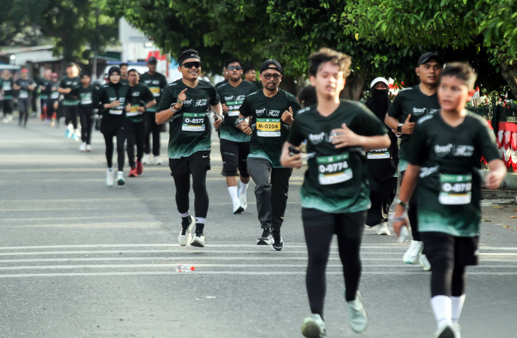 Participants run toward the finish line during the Lila Wangsa Run 2026 in Lhokseumawe, Aceh, Indonesia, Sunday, Aug. 9, 2026. 