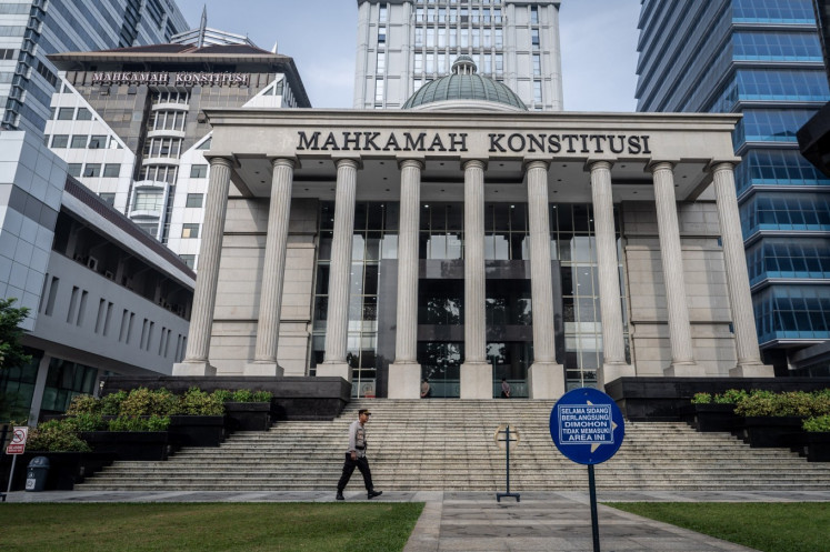 A police officer patrols the grounds of the Constitutional Court in Central Jakarta on Feb. 4, 2025. 