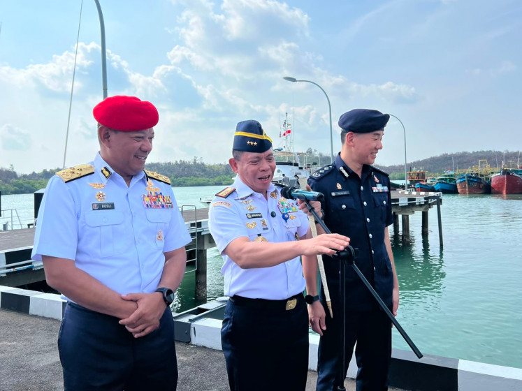 Indonesian Maritime Security Agency (Bakamla) head Vice Adm. Irvansyah (center) is flanked by Malaysian Maritime Enforcement Agency (MMEA) director general Adm. Mohd. Rosli bin Abdullah (left) and Singapore Police Coast Guard commander Sr. Asst. Comr. Ang Eng Seng during the opening ceremony of the inaugural INSIMA trilateral exercise on Aug. 11 in Batam, Riau Islands. The trilateral exercise involved 60 personnel and three patrol vessels from the three participating countries.