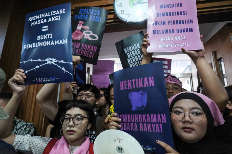 Activists display posters reading &ldquo;Criminalizing Protesters = Evidence of Silencing&ldquo; and &ldquo;Stop Silencing the People's Voice&ldquo; on March 6 at the Central Jakarta District Court when the court acquitted activists Delpedro Marhaen Rismansyah, Khariq Anhar, Muzaffar Salim and Syahdan Husein in their trial for incitement in relation to the anti-government protests in August-September 2025.