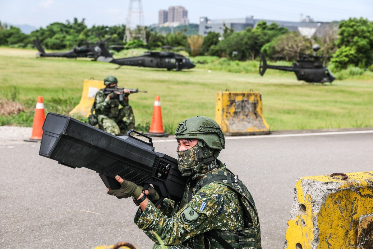 A Taiwanese soldier operates an anti-drone gun while providing security for helicopters during a fuel and ammunition resupply drill as part of the annual Han Kuang military exercise in Taoyuan on Aug. 11, 2026.