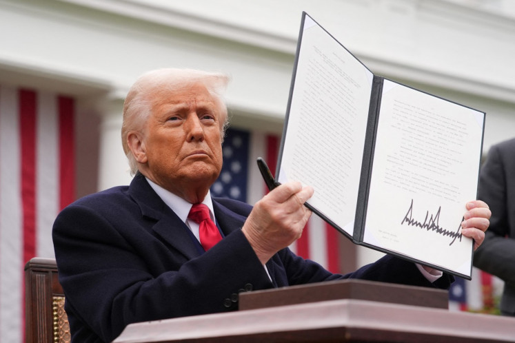 US President Donald Trump displays a signed executive order imposing tariffs on imported goods during a &ldquo;Make America Wealthy Again&rdquo; trade announcement event in the Rose Garden at the White House in Washington, DC, on April 2, 2025. 