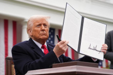 US President Donald Trump displays a signed executive order imposing tariffs on imported goods during a &ldquo;Make America Wealthy Again&rdquo; trade announcement event in the Rose Garden at the White House in Washington, DC, on April 2, 2025. 