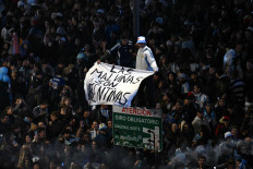 Argentina's fans hold a banner reading &ldquo;The Malvinas are Argentine&ldquo; on July 19 as they gather near the Obelisk after Argentina lost the FIFA World Cup final soccer match against Spain in Buenos Aires.