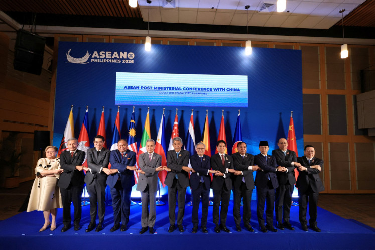 Chinese Foreign Minster Wang Yi poses for a group photo with ASEAN foreign ministers during the ASEAN Post Ministerial Conference with China on the sidelines of the ASEAN Foreign Ministers' Meeting in Pasay, Metro Manila, on July 22, 2026. 