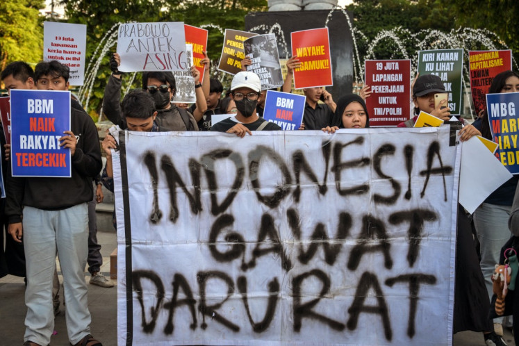 Student protestors hold banners, including one reading "Indonesia in Emergency", during a rally against a rise of non-subsidized fuel prices and the free nutritious meal program on June 15 in Surabaya, East Java.