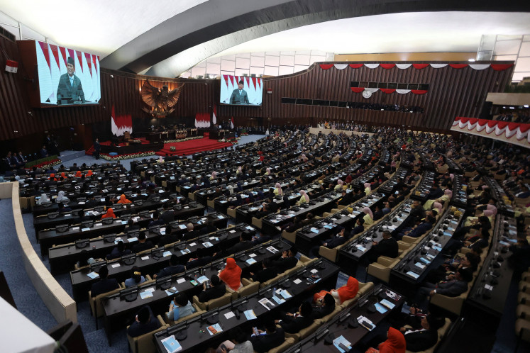 President Prabowo Subianto is displayed on screens as he delivers his annual state of nation address in front of legislator while Vice President Gibran Rakabuming Raka sits next to him, on Aug. 14 ahead of the country's 81st Independence Day anniversary, in Jakarta.