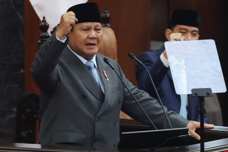 President Prabowo Subianto, along with Vice President Gibran Rakabuming Raka, gesture as he shouts 'Merdeka&rsquo; or 'Freedom&rsquo;, during his annual state of the nation address before the members of the Parliament, ahead of the country's 81st Independence Day, on Aug. 14 in Jakarta.