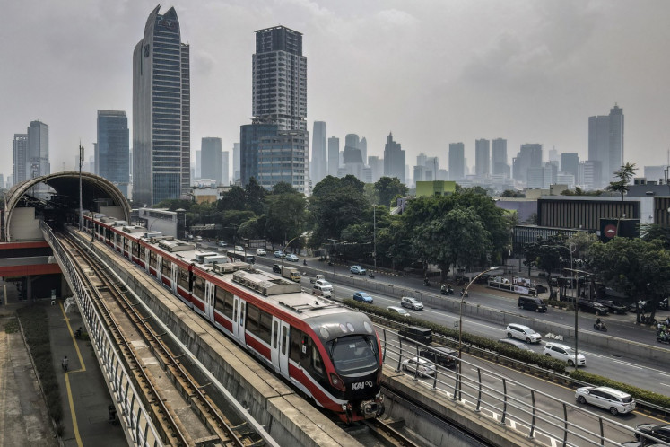 A passenger train runs on an elevated track in Jakarta's central business district on Aug. 5, 2025.