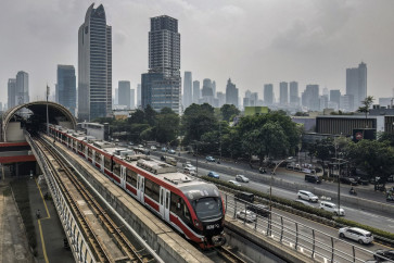 A passenger train runs on an elevated track in Jakarta's central business district on Aug. 5, 2025.