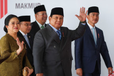President Prabowo Subianto (center) and House of Representatives speaker Puan Maharani (left) wave, as they arrive on Aug. 14 at the Senayan Legislative Complex, ahead of the country's 81st Independence Day anniversary, in Central Jakarta.
