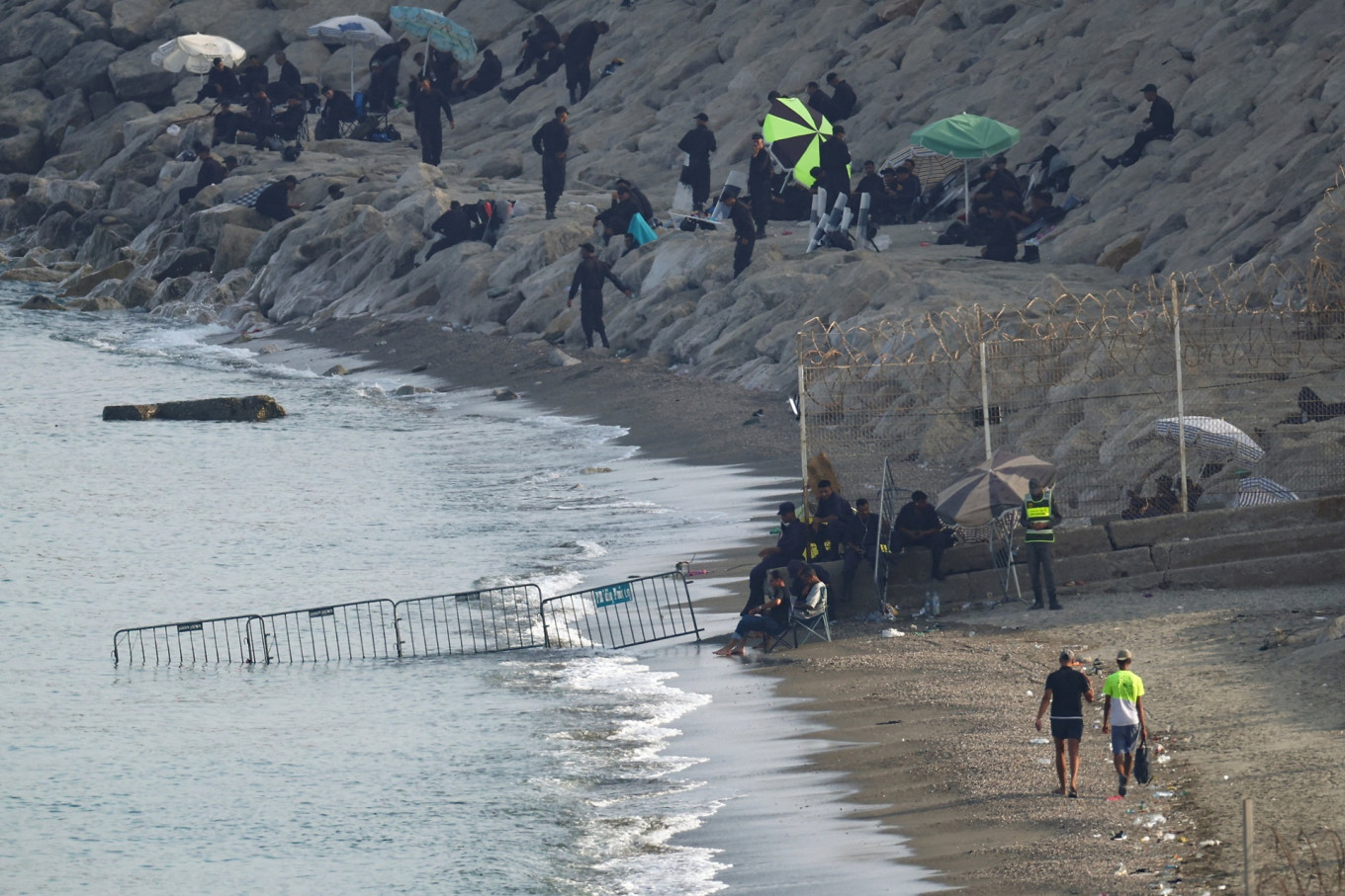 View of barriers on Morocco side of the border with Spain in Ceuta, Spain on Aug. 14, 2026 following mass crossings of migrants on foot and by sea from Morocco into the Spanish territory.