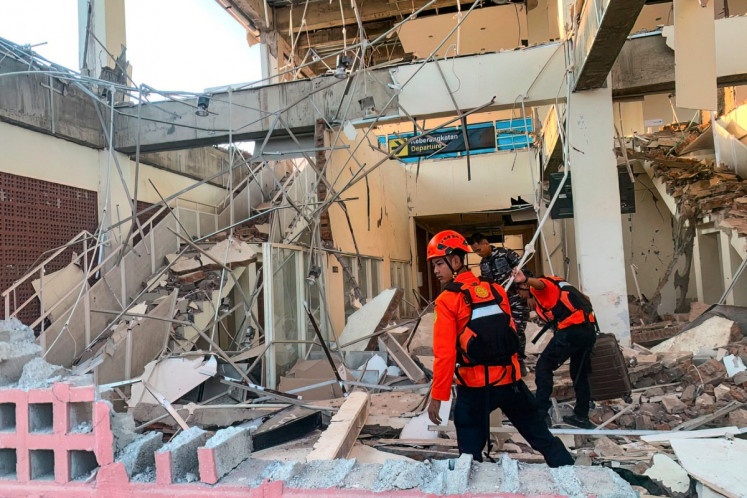 This handout picture taken and released on Aug. 15, 2026 by Indonesia's National Search and Rescue Agency (BASARNAS) shows rescuers working amid the rubble of a damaged building after an earthquake in Maumere, East Nusa Tenggara. A powerful 7.7-magnitude earthquake struck off Flores island in eastern Indonesia early on Aug. 15, killing at least two and sending thousands running in panic after authorities issued a tsunami warning.