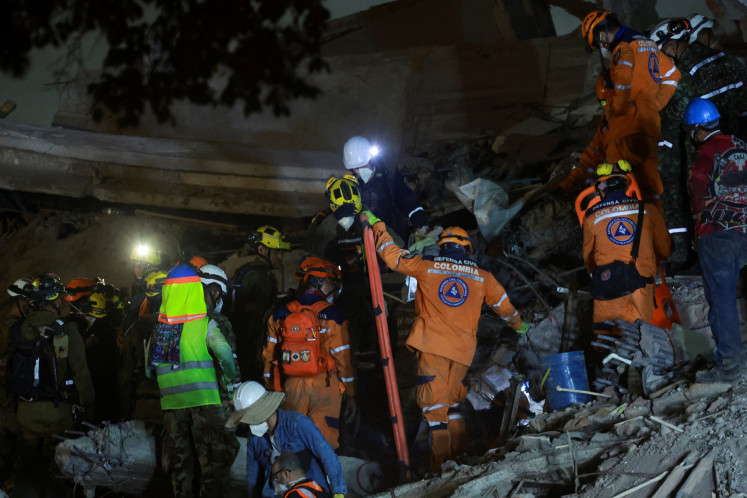 Rescuers work amid the rubble of the Edificio Vanessa in the aftermath of an earthquake in Cali, Colombia, on Aug. 14, 2026.