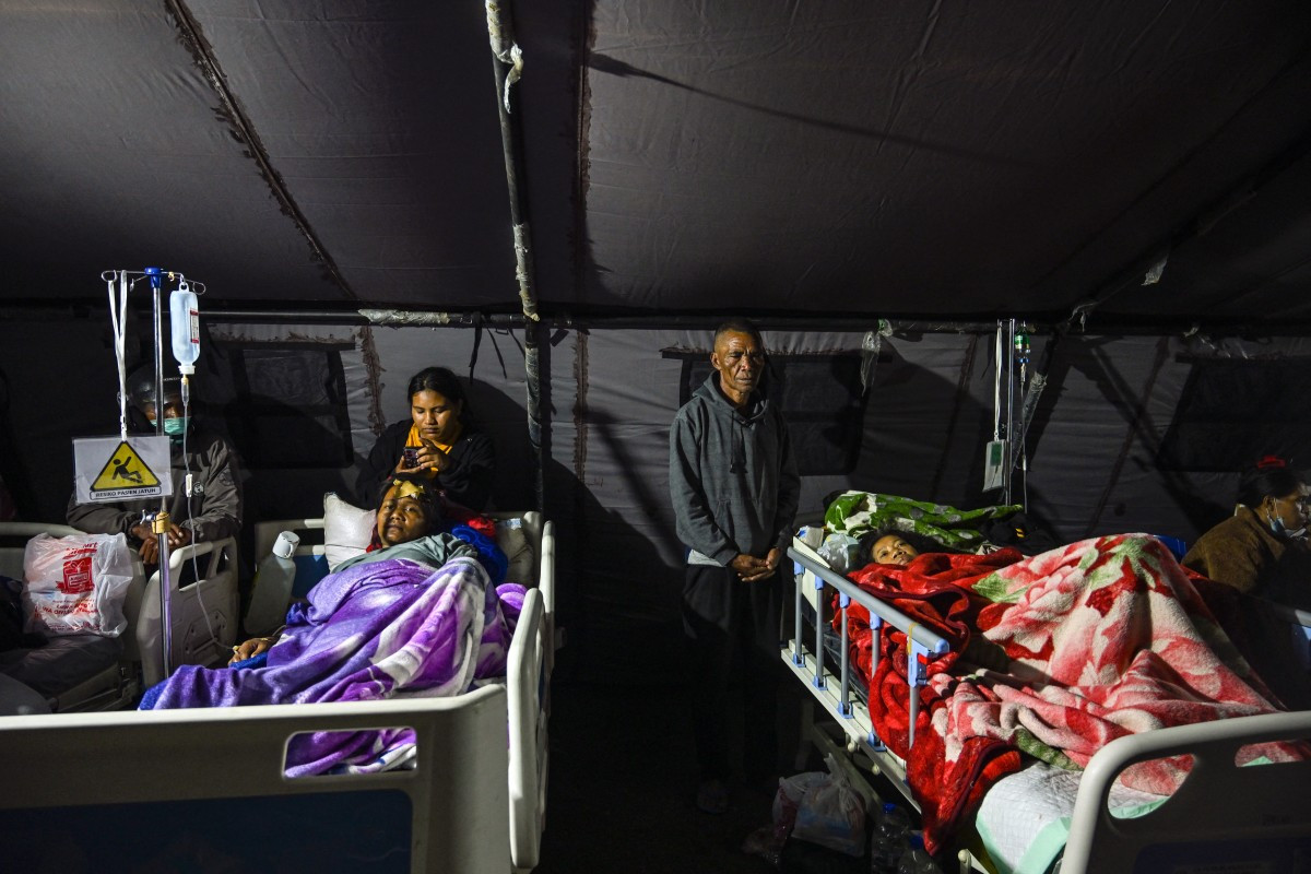 Earthquake victims are treated in a temporary medical tent due to fears of aftershocks, on August 15 in front of the Ruteng hospital in Ruteng, Manggarai, East Nusa Tenggara (NTT). Rescuers combed through debris for survivors after a powerful earthquake struck off Flores Island, killing at least 47 people, according to disaster officials.
