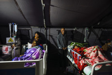 Earthquake victims are treated in a temporary medical tent due to fears of aftershocks, on August 15 in front of the Ruteng hospital in Ruteng, Manggarai, East Nusa Tenggara (NTT). Rescuers combed through debris for survivors after a powerful earthquake struck off Flores Island, killing at least 47 people, according to disaster officials.