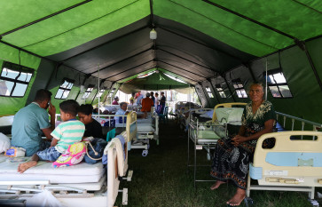 People in a makeshift hospital tent outside a damaged hospital, in the aftermath of an earthquake in Nagekeo, East Nusa Tenggara (NTT), on August 17, 2026.
